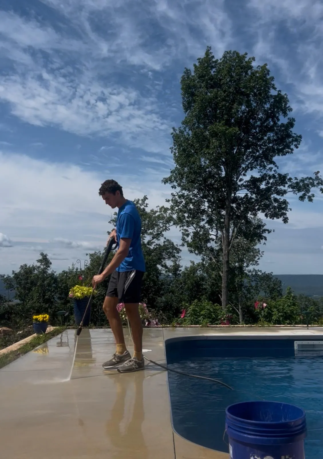 Maximus Fayrweather pressure washing a pool deck in Huntsville