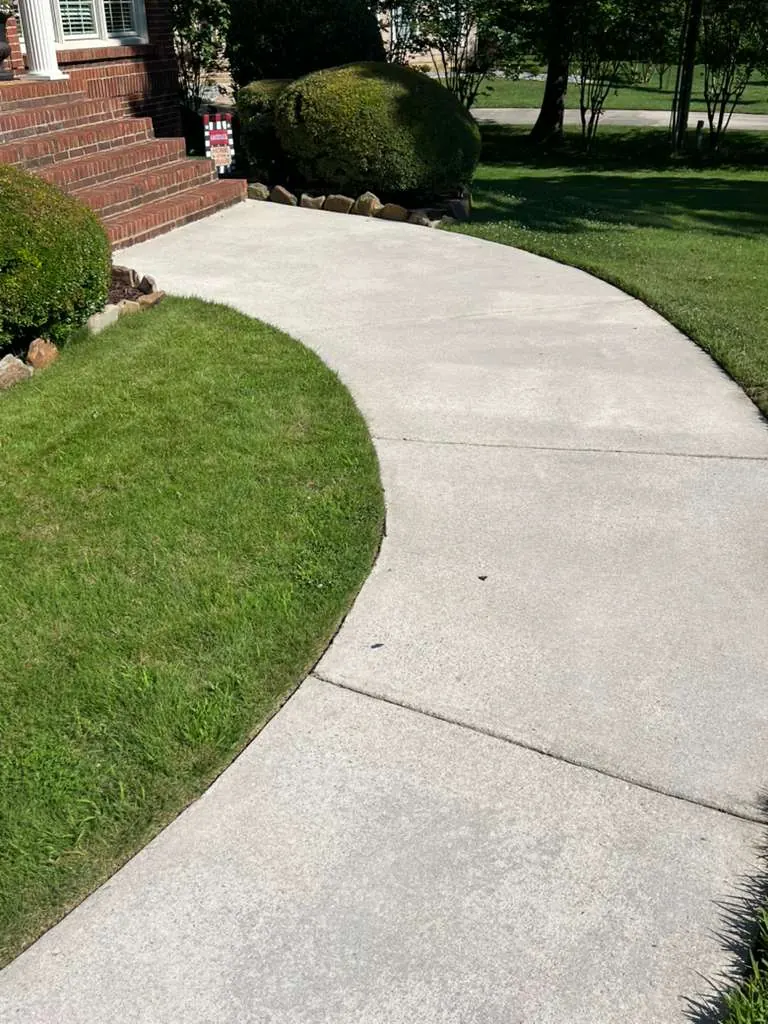 Bright clean curved walkway after pressure washing